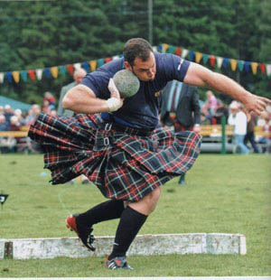 A competitor wearing traditional Scottish garb competing in the highland games