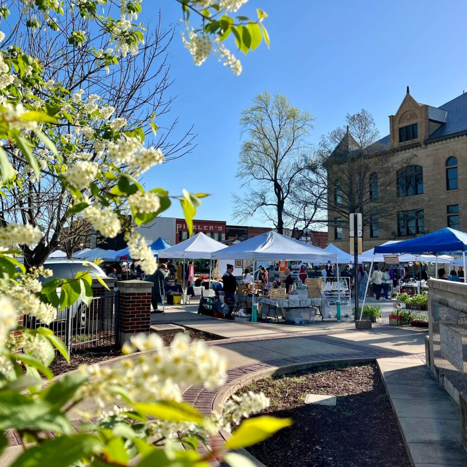 A photograph showcasing the booths and grounds of the farmers' market