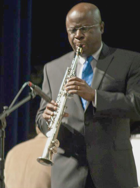 A photograph of a musician performing on a brass instrument at the Phi Mu Alpha Jazz Festival.