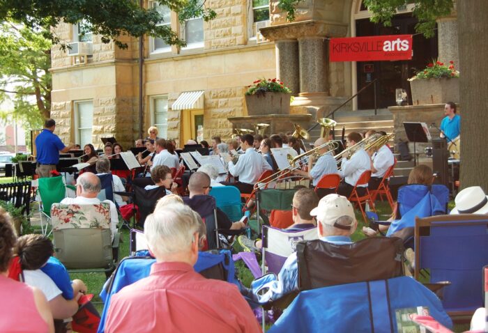 A photograph of the crowd gathered outdoors to watch the live music at the summer on the square concert