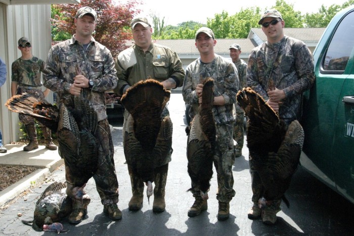 Photograph of four Turkey hunters posing with their turkeys