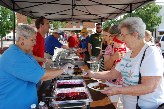 Photograph of residents both serving and being served the pancake breakfast
